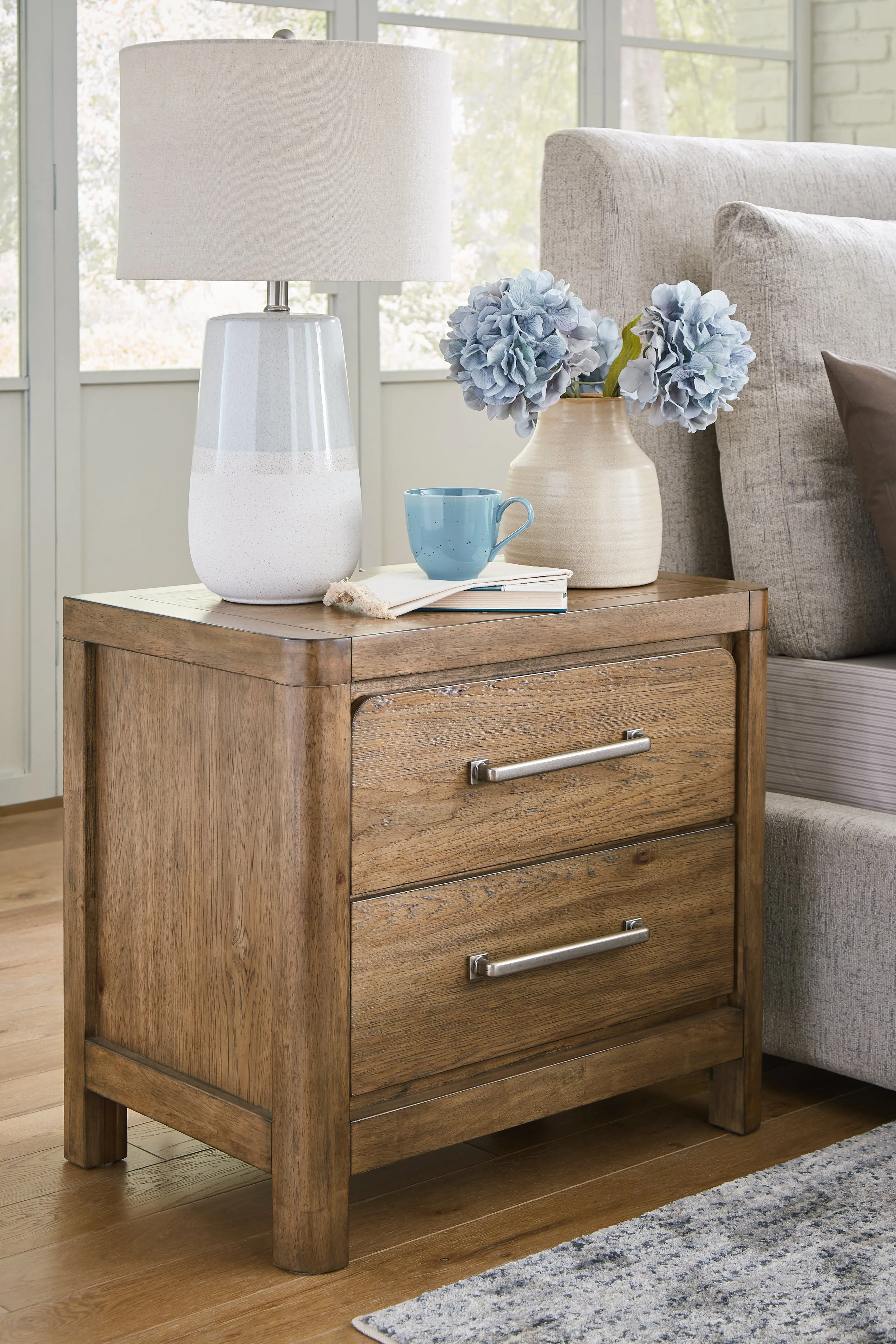 Cabalynn California King Panel Bed with Storage with Mirrored Dresser, Chest and Nightstand in Light Brown